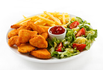 Fried chicken nuggets, French fries and vegetables