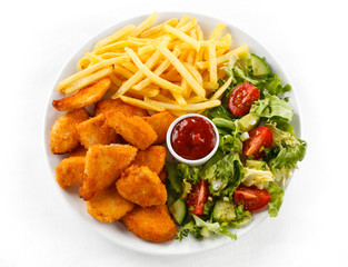 Fried chicken nuggets, French fries and vegetables