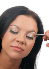 Fototapeta premium Which girl puts shadows the professional visagiste.