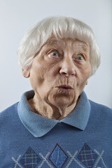 Amazed senior woman head and shoulders portrait