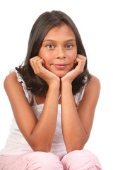 Fototapeta premium Teenage girl sitting chin on hands in relaxed pose