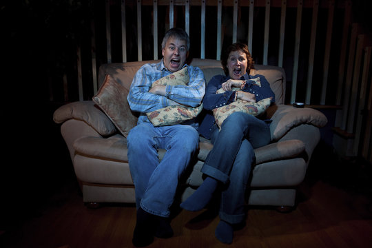 Couple Watching Scary Movie On TV