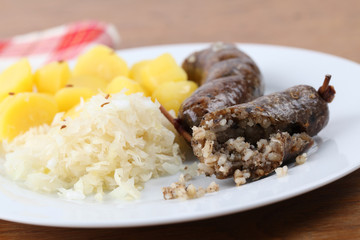 Traditional Czech white pudding with potatoes and sauerkraut