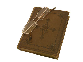 Old book with brown leather cover and gold-rimmed spectacles