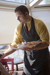 Waiter cleaning table
