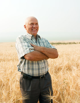 man standing in field of wheat