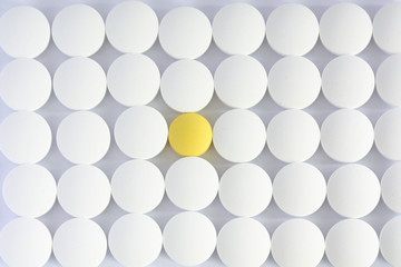 pattern of white tablets with one that stands out