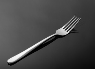 Abstract image for kitchen. Fork with reflection.