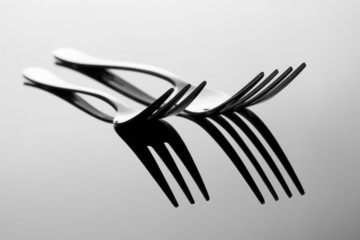 Abstract image for kitchen.Two Forks with reflection.