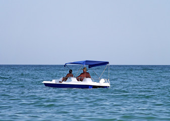 Two old people in catamaran in the sea