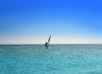surfer on blue sea under sky