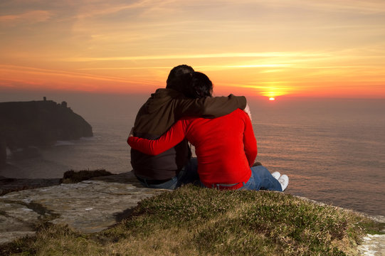 Loving Couple At Sunset On Irish Cliffs Of Moher