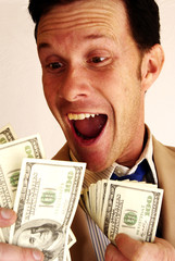 Excited man in suit with hundred dollar bills