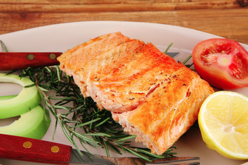 roast salmon on plate over wood