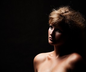 Beautiful studio portrait in dark tones of model