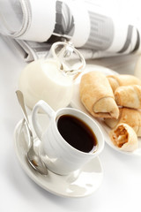 Cup of fragrant coffee on a morning paper business news