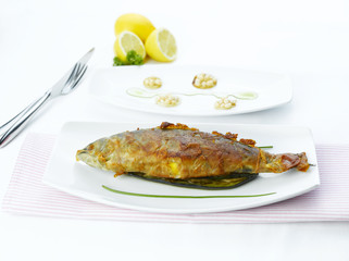 White fried fish on vegetables