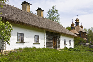 Fototapeta na wymiar Village house and wooden church