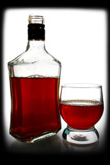 alcohol drink is in a bottle and glass