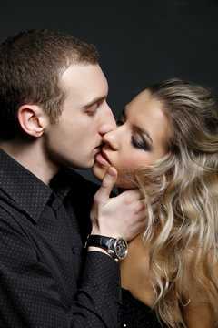 handsome man kissing a beautiful woman
