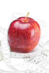 apple and measure tape isolated on white