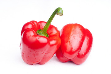 two red paprikas on white background