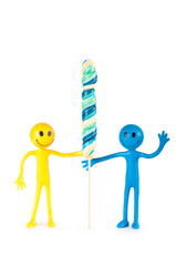 Smiley holding colourful lollipop isolated on white