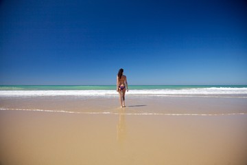 woman walking at seashore in Conil beach