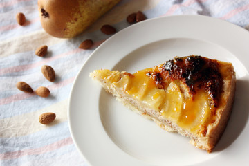 Pear cake with almond cream and peach-rosemary glaze