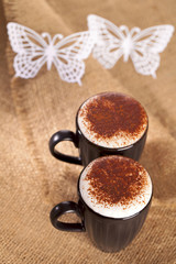 hot frothy drink cappuccino chokolate dusted, white paper butter
