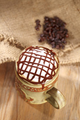 hot frothy  coffee cappuccino chocolate topping, in rustic style
