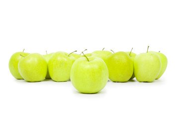 Green and yellow apples on a white baclground
