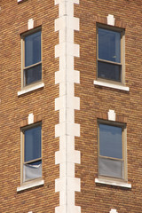 Fototapeta na wymiar Windows on Brown Brick Building