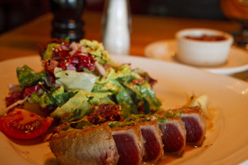 Grilled Ahi Tuna on a Plate with Salad in Restaurant