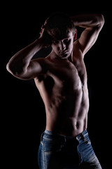 Fototapeta na wymiar Posing muscular naked man on black