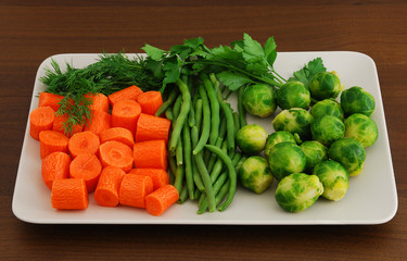 Colorful mix of vegetables on rectangular grey ceramic dish