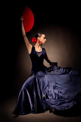 young woman dancing flamenco on black © artjazz
