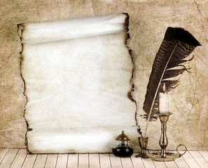 Old paper with a candle and a quill pen.