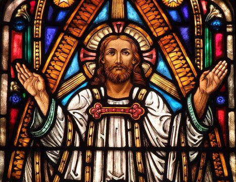 Stained Glass window of Jesus with his hands up