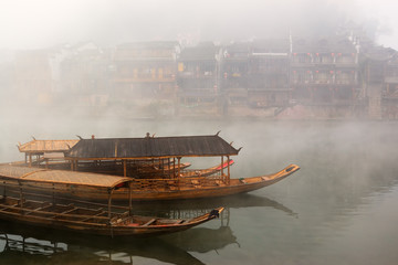 China river landscape with boats and traditional architecture