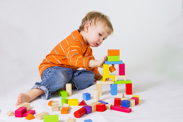 2 years old baby boy playing with wooden blocks