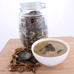 Mushroom soup, dried mushrooms and an antique spoon