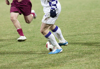 Soccer players running after the ball