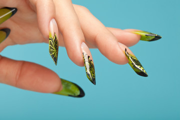Fingers with beautiful manicure in natural green style