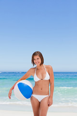 Fototapeta na wymiar Cute woman with her ball on the beach
