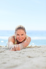 Fototapeta na wymiar A woman sunbathing at the beach