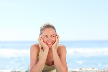 Fototapeta na wymiar Lovely woman sunbathing at the beach