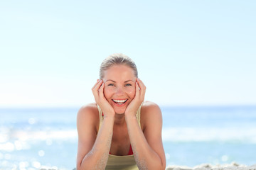 Lovely woman sunbathing at the beach