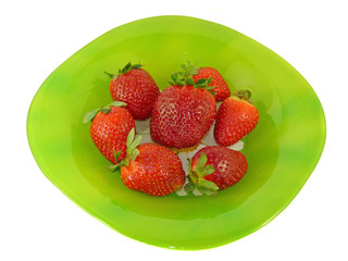 Appetizing strawberries on a green plate, isolation