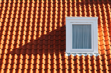 Red tile roof with a window